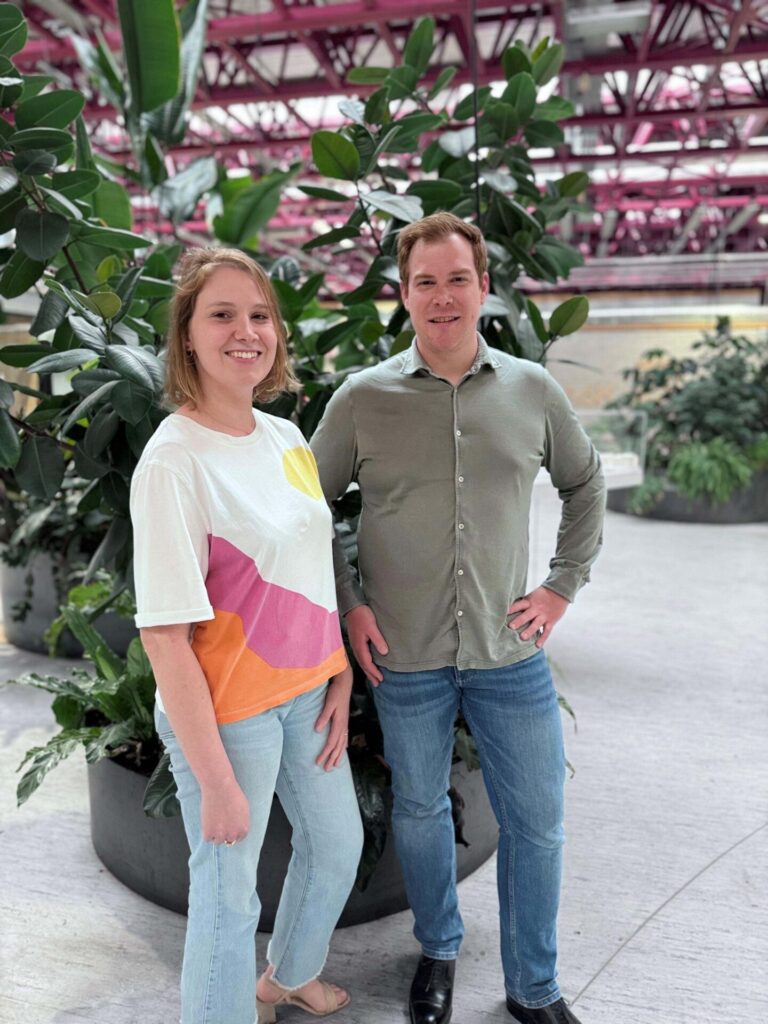 François-Xavier Dalle Rive en een vrouw poseren voor een grote groene plant in een industriële omgeving